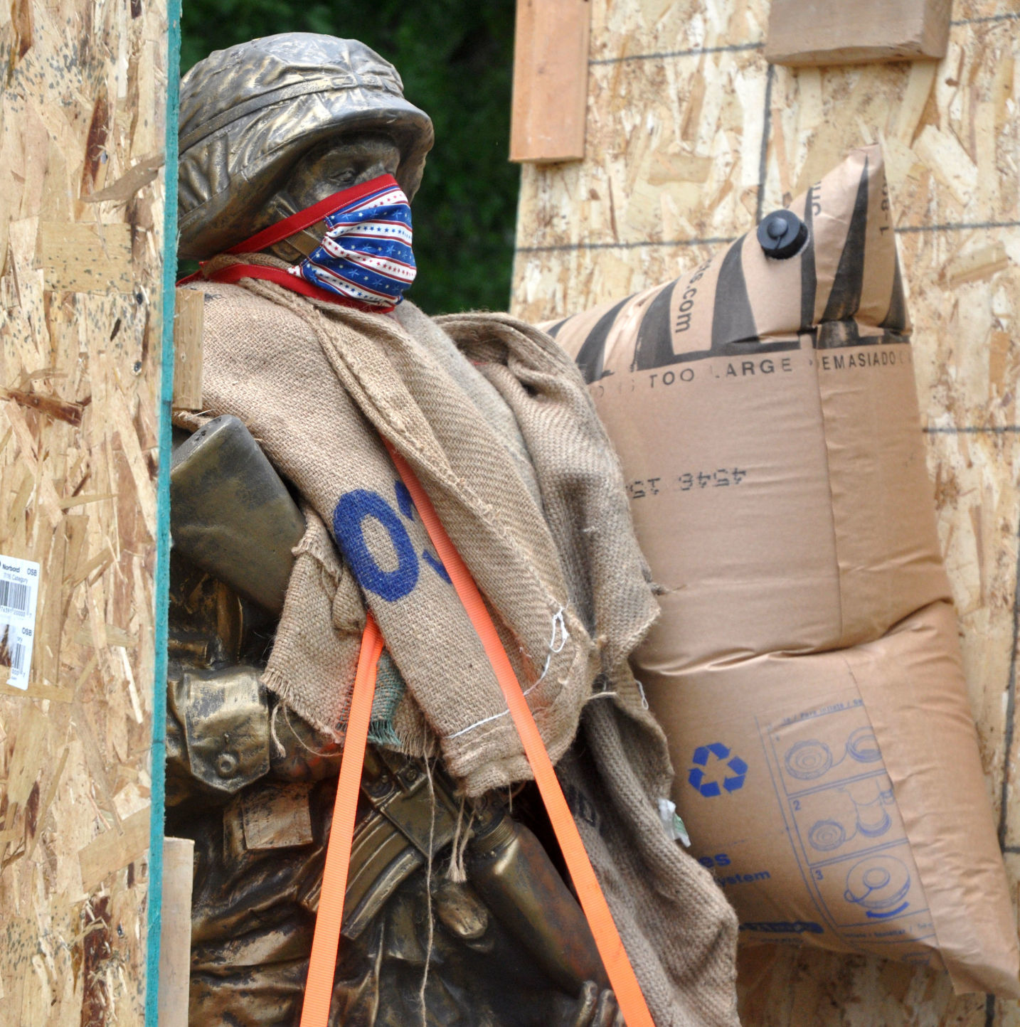A statue, depicting a military soldier, is unveiled as it is being prepared to be installed